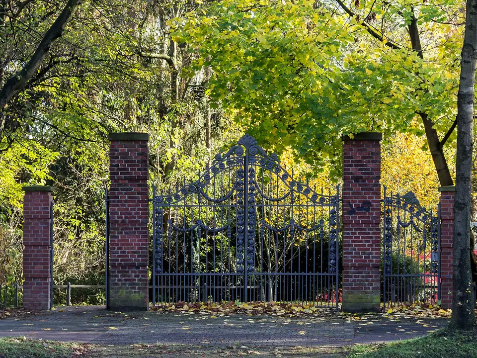 Example of wrought iron driveway gates between brick pillars