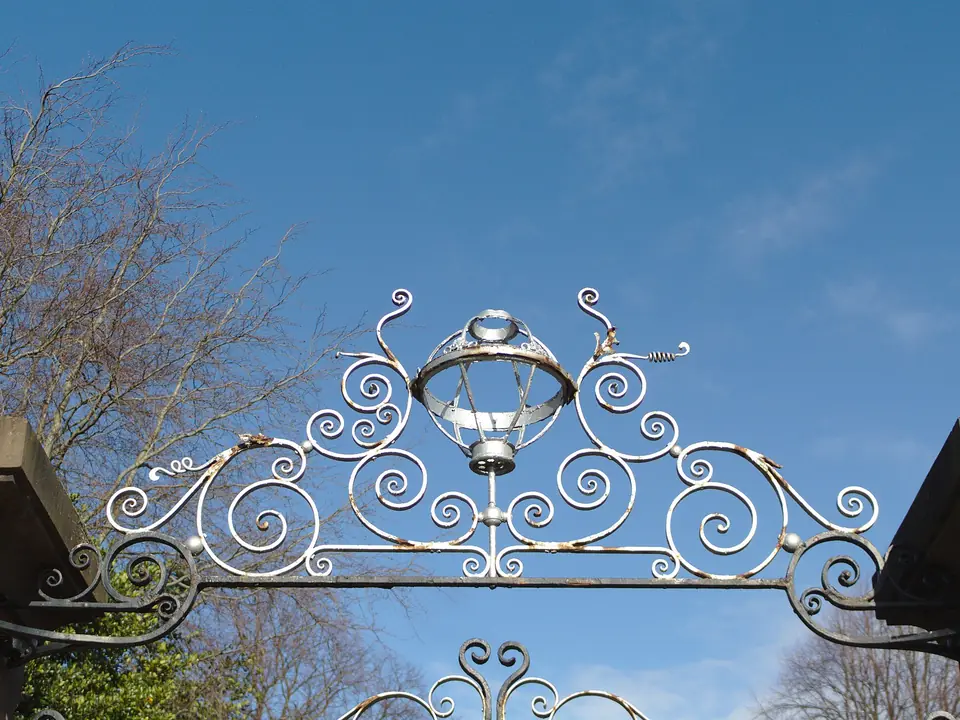 Example of a scrollwork wrought iron gate overthrow