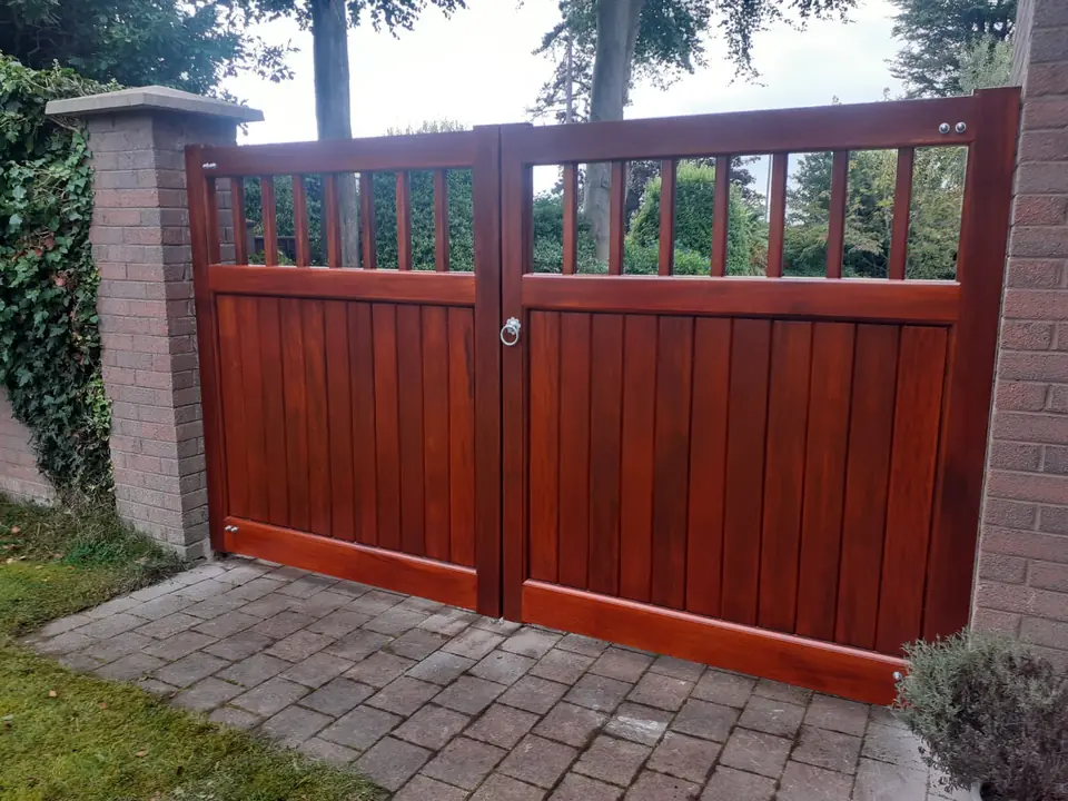 Bespoke natural Iroko hardwood driveway gates made by PJ Gates & Automation