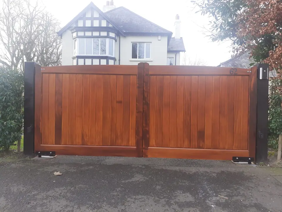 Bespoke natural Iroko hardwood driveway gates made by PJ Gates & Automation