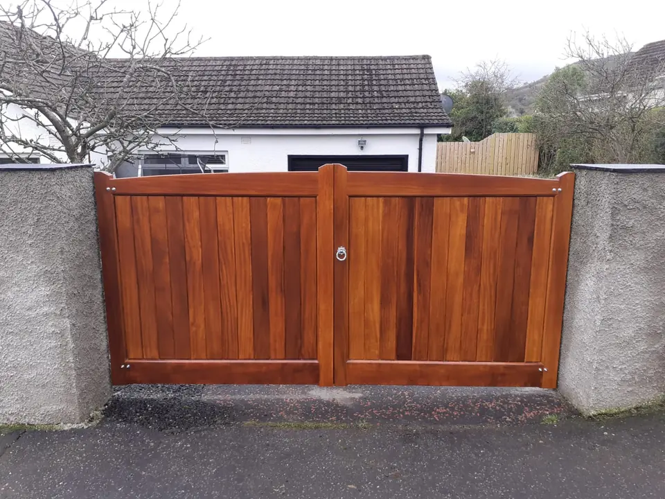 Bespoke natural Iroko hardwood driveway gates made by PJ Gates & Automation