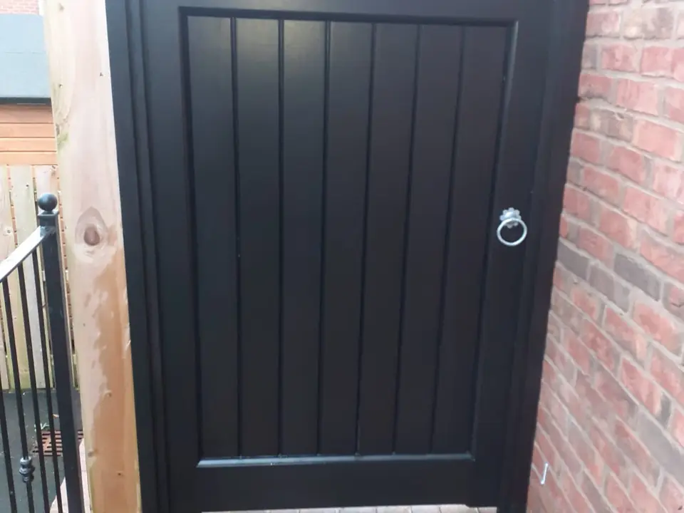 Bespoke dark-finish driveway gates made by PJ Gates & Automation