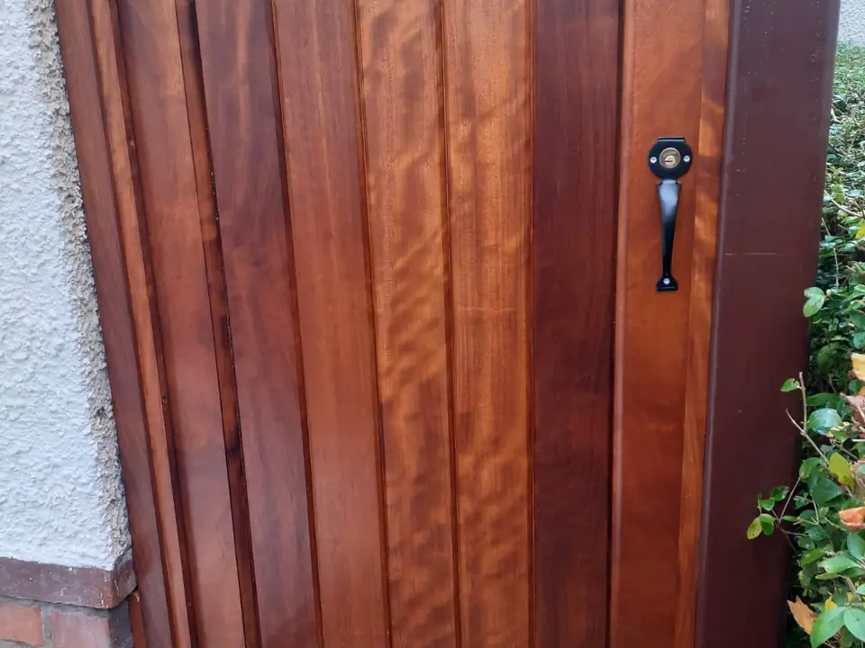 Bespoke natural Iroko hardwood driveway gates made by PJ Gates & Automation