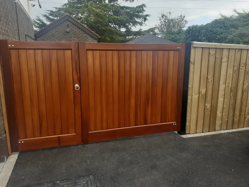 Bespoke natural Iroko hardwood driveway gates made by PJ Gates & Automation