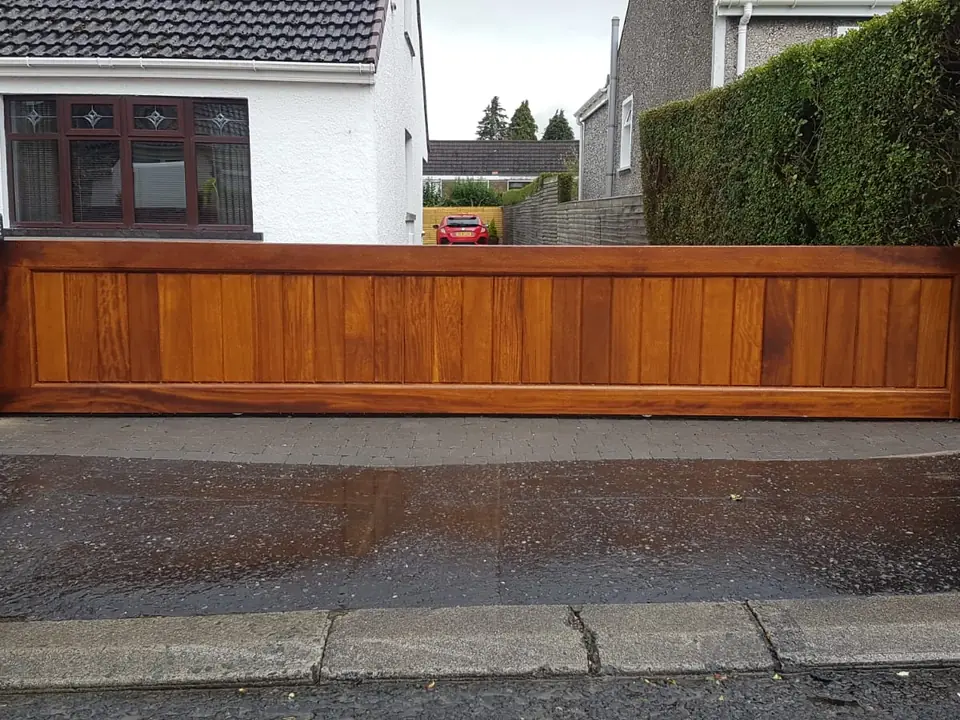 Bespoke natural Iroko hardwood driveway gates made by PJ Gates & Automation