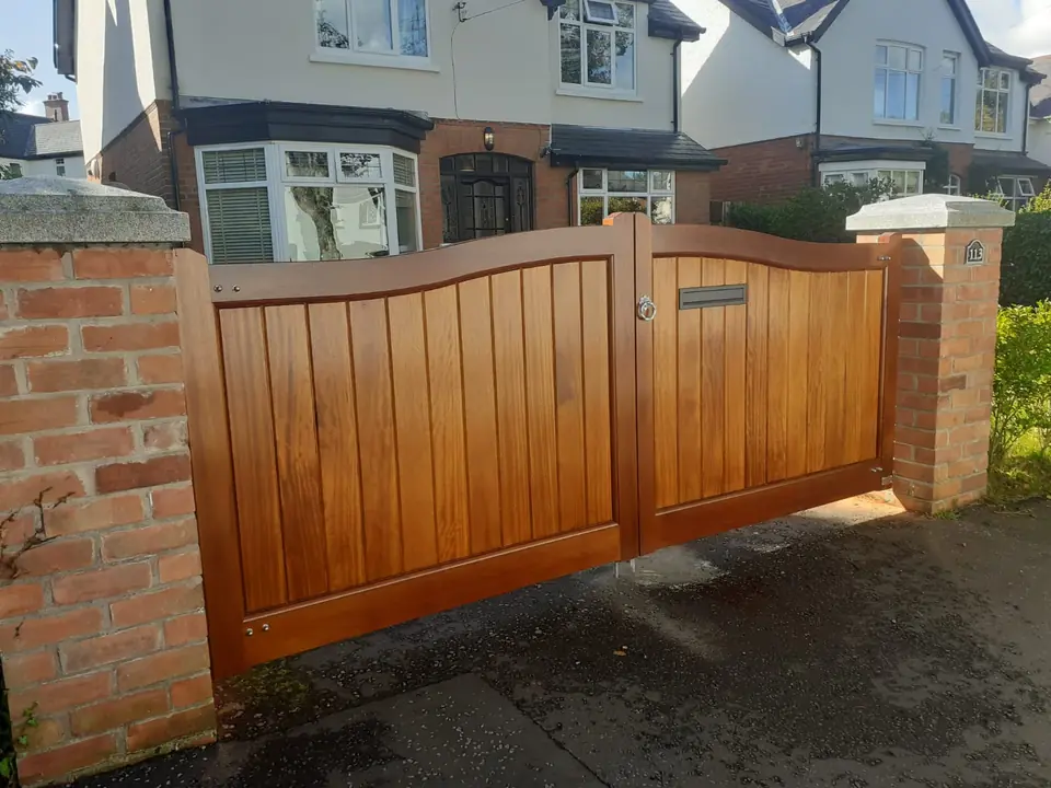 Bespoke natural Iroko hardwood driveway gates made by PJ Gates & Automation