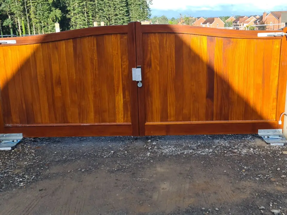 Bespoke natural Iroko hardwood driveway gates made by PJ Gates & Automation