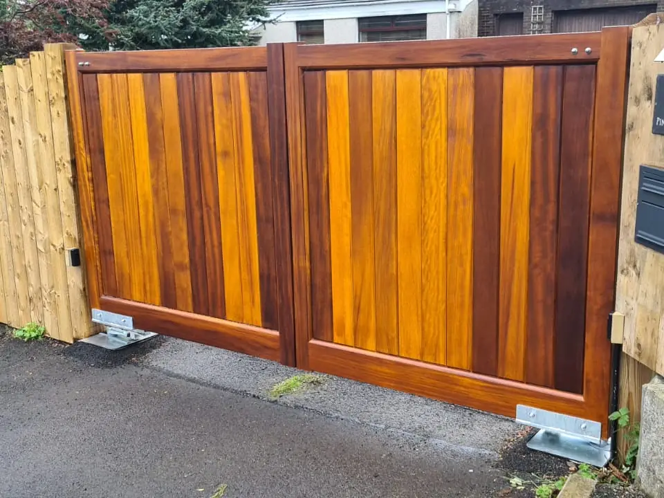Bespoke natural Iroko hardwood driveway gates made by PJ Gates & Automation