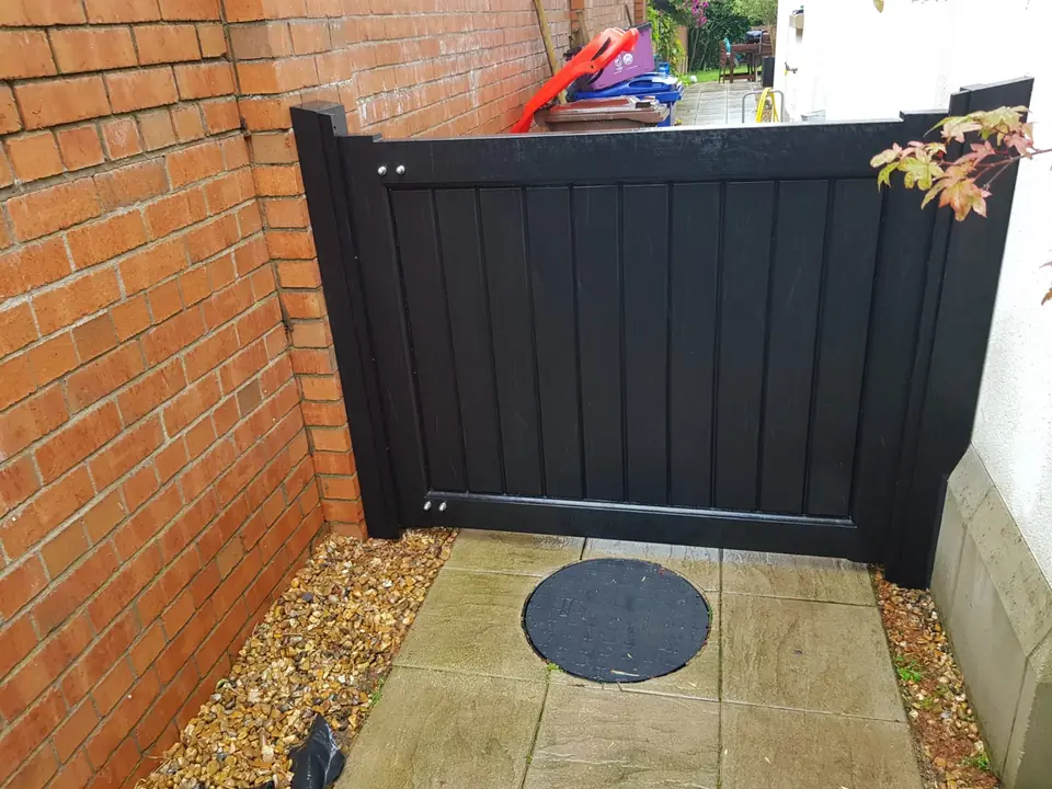 Bespoke dark-finish driveway gates made by PJ Gates & Automation