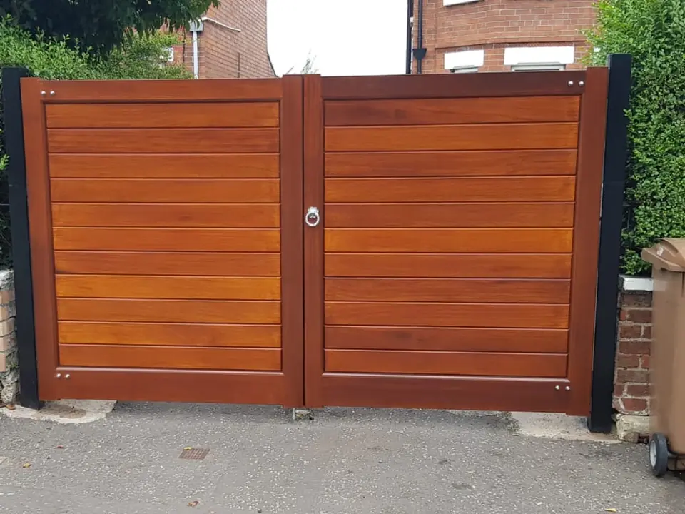 Bespoke natural Iroko hardwood driveway gates made by PJ Gates & Automation