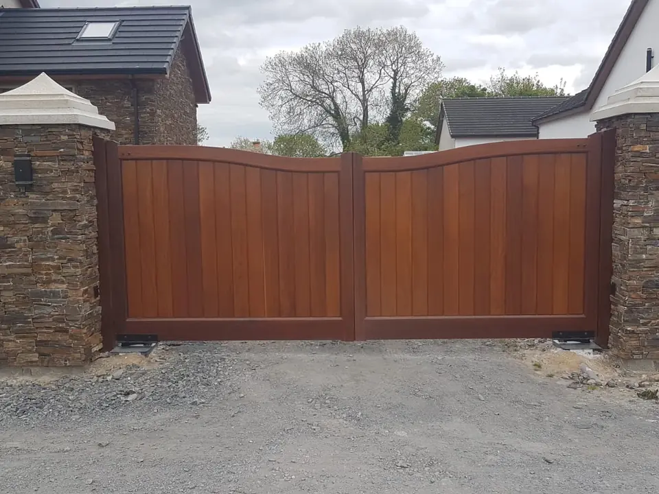 Bespoke natural Iroko hardwood driveway gates made by PJ Gates & Automation