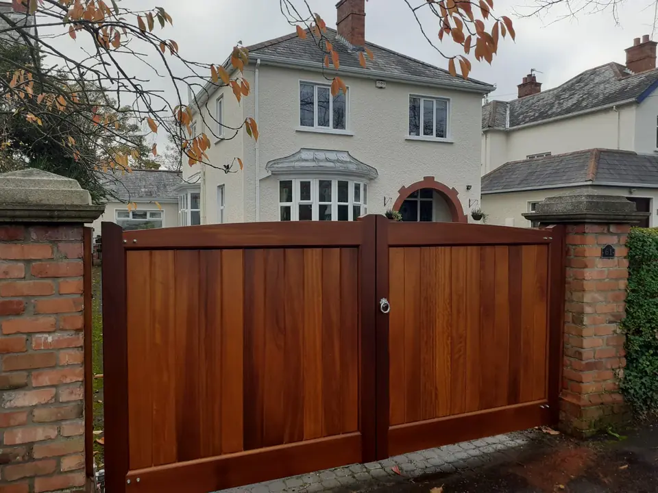 Bespoke natural Iroko hardwood driveway gates made by PJ Gates & Automation