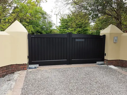 Bespoke dark-finish driveway gates made by PJ Gates & Automation