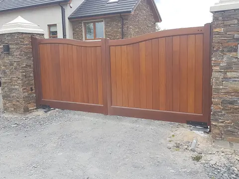 Bespoke natural Iroko hardwood driveway gates made by PJ Gates & Automation