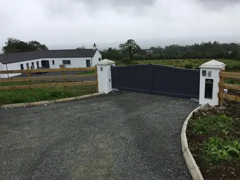 Bespoke dark-finish driveway gates made by PJ Gates & Automation