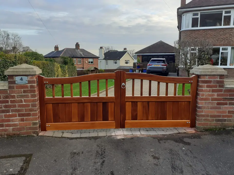 Bespoke natural Iroko hardwood driveway gates made by PJ Gates & Automation