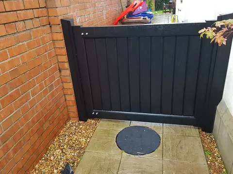 Bespoke dark-finish driveway gates made by PJ Gates & Automation