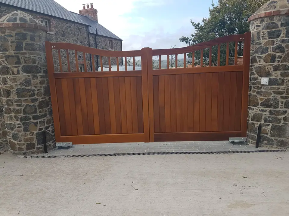Bespoke natural Iroko hardwood driveway gates made by PJ Gates & Automation