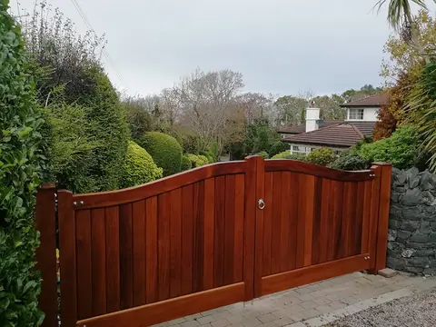 Bespoke natural Iroko hardwood driveway gates made by PJ Gates & Automation