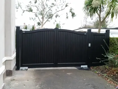 Bespoke dark-finish driveway gates made by PJ Gates & Automation