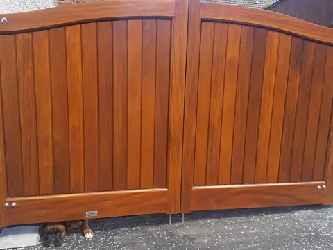 Bespoke natural Iroko hardwood driveway gates made by PJ Gates & Automation