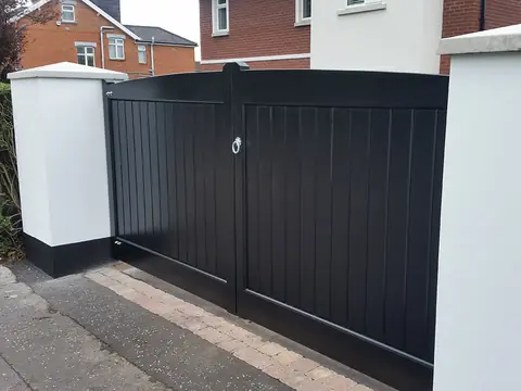 Bespoke dark-finish driveway gates made by PJ Gates & Automation