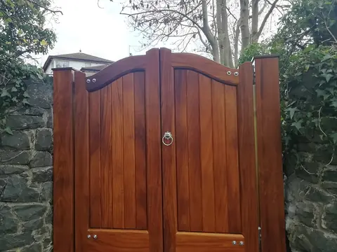 Bespoke natural Iroko hardwood driveway gates made by PJ Gates & Automation