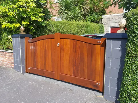 Bespoke natural Iroko hardwood driveway gates made by PJ Gates & Automation