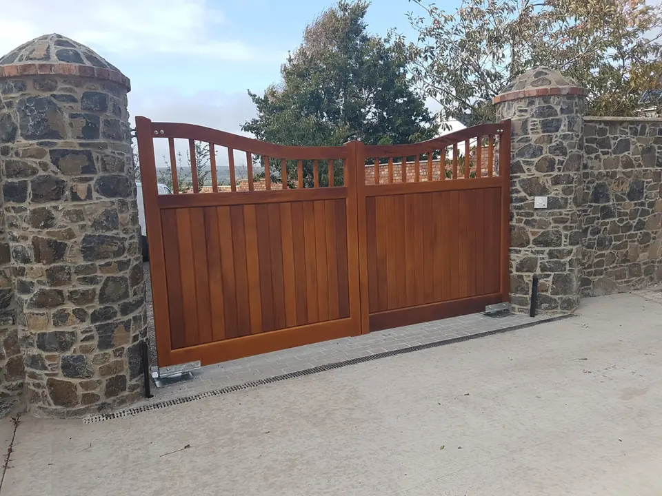 Bespoke natural Iroko hardwood driveway gates made by PJ Gates & Automation
