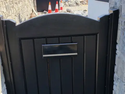 Bespoke dark-finish driveway gates made by PJ Gates & Automation