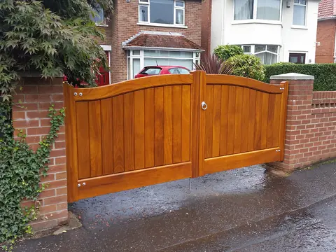 Bespoke natural Iroko hardwood driveway gates made by PJ Gates & Automation