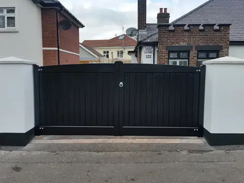 Bespoke dark-finish driveway gates made by PJ Gates & Automation