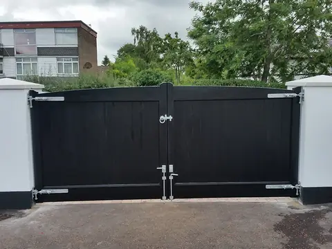 Bespoke dark-finish driveway gates made by PJ Gates & Automation