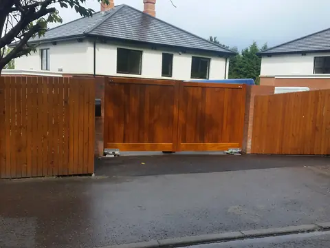 Bespoke natural Iroko hardwood driveway gates made by PJ Gates & Automation