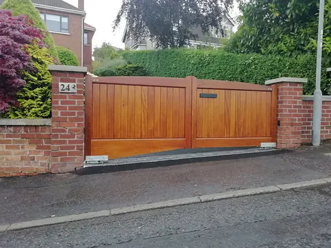 Bespoke natural Iroko hardwood driveway gates made by PJ Gates & Automation