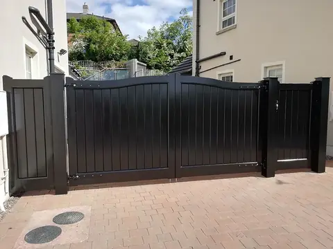 Bespoke dark-finish driveway gates made by PJ Gates & Automation