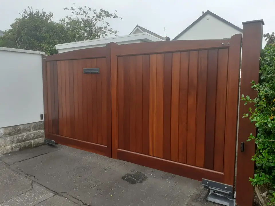 Bespoke natural Iroko hardwood driveway gates made by PJ Gates & Automation