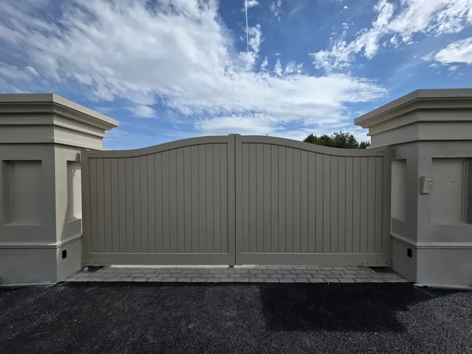 Seymour style painted timber driveway gates with a curved top